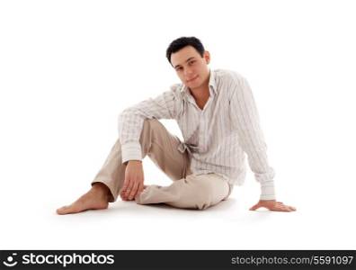 relaxed man sitting on the floor over white