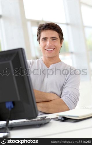 Relaxed man working in office