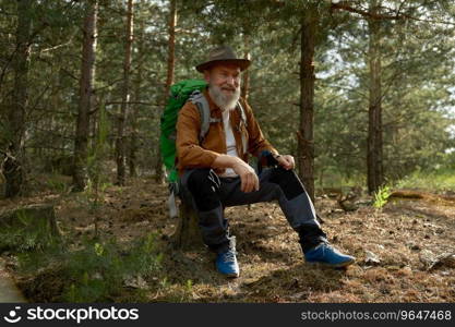 Relaxed senior man traveler rest having halt in forest during touristic rout trip. Healthy active hobby on retirement concept. Relaxed senior man traveler rest having halt in forest