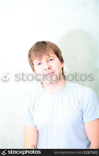 relaxed white man against of the rooms wall