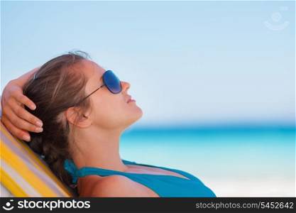 Relaxed woman laying on beach