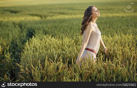 Relaxed woman on the green corn field