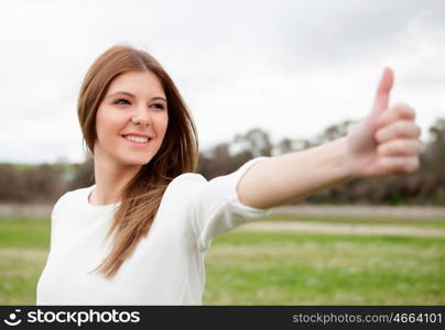 Relaxed woman saying Ok with her hand in the meadow