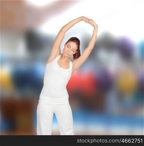 Relaxed woman stretching her arms in a pilates class