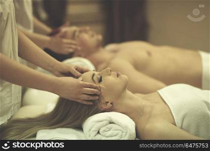 relaxed young couple getting massage in spa and wellness salon. relaxed young couple getting massage in spa