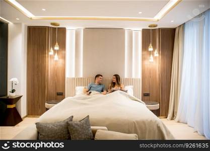 Relaxed young lovers in the luxurious apartment in the night