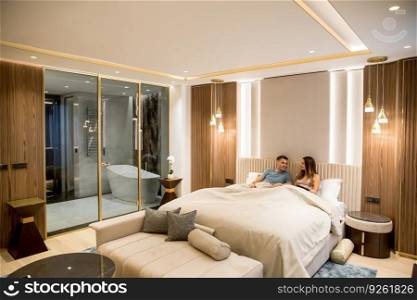 Relaxed young lovers in the luxurious apartment in the night