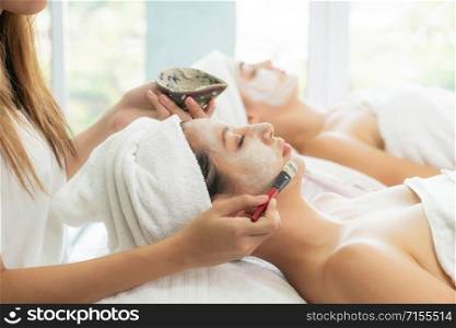 Relaxed young woman at the luxury wellness spa.. Beautiful woman having a facial treatment at spa.