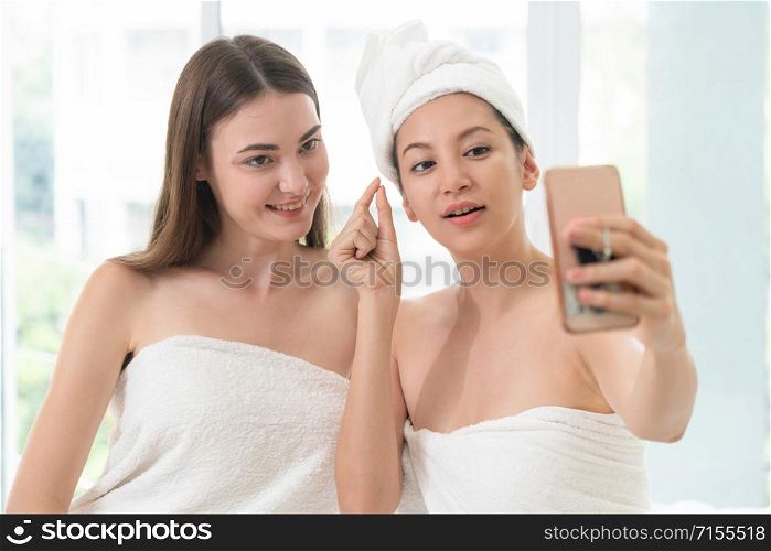 Relaxed young woman at the luxury wellness spa.. Happy women takes selfie with mobile phone in spa.