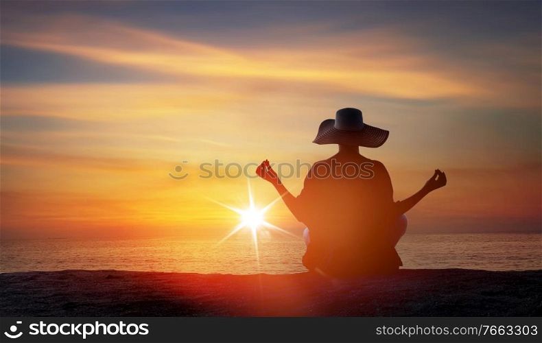 Relaxed, young woman meditating on a tropical beach