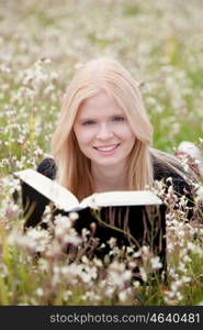 Relaxed young woman reading a book on nature