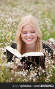 Relaxed young woman reading a book on nature