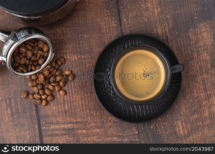 Relaxing americano coffee in black porcelain cup on wooden table