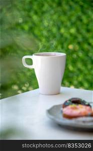 Relaxing americano coffee in white porcelain cup on stone table