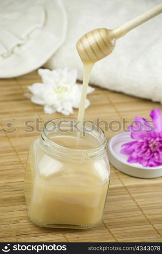 relaxing aroma of almond coconut vanilla milk and honey bath foam over wooden mat