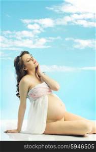 Relaxing beautiful pregnant woman with curly haistyle