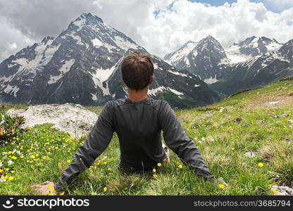 Relaxing boy in mountains