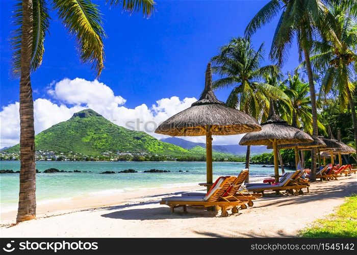 Relaxing holidays in tropical paradise. Mauritius island. Flic en Flac beach, view of Tamarin mountain. Mauritius island . Flic en Flac beach