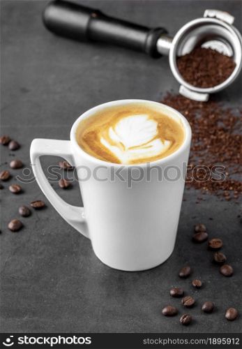 Relaxing latte coffee in white porcelain cup on stone table