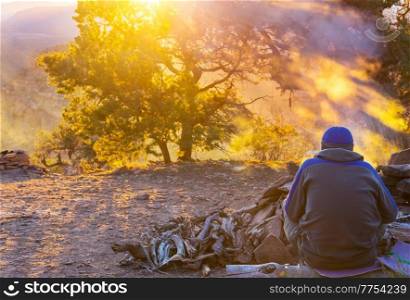 Relaxing man in the beautiful mountains at sunrise