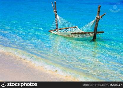 relaxing tropical holidays - hammock in turquoise water
