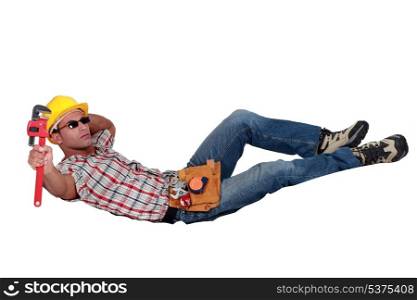 Relaxing workman with a wrench