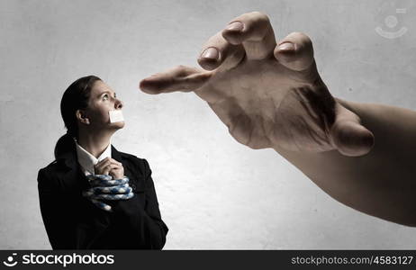 Release of guiltless accused. Young businesswoman with tape on mouth and tired hands