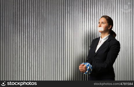 Release of guiltless accused. Young businesswoman with tape on mouth and tired hands