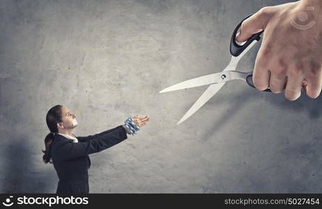 Release of guiltless accused. Young speechless businesswoman with tied hands and adhesive tape on mouth