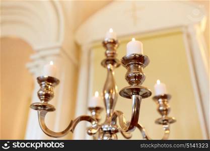 religion and christianity concept - candles burning in orthodox church. candles burning in orthodox church