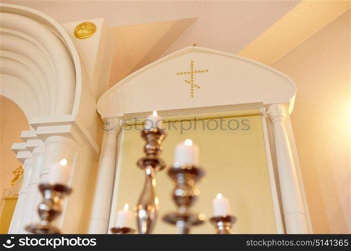 religion and christianity concept - candles burning in orthodox church. candles burning in orthodox church
