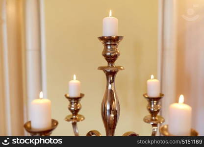 religion and decoration concept - candles burning in church or palace. candles burning in church or palace