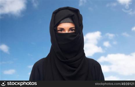 religious and people concept - muslim woman in hijab over blue sky and clouds background. muslim woman in hijab over white background