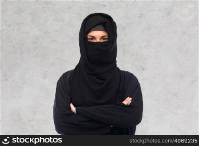 religious and people concept - muslim woman in hijab over gray concrete wall background. muslim woman in hijab over gray background