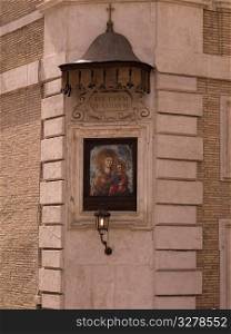Religious painted plaque on building in Rome Italy