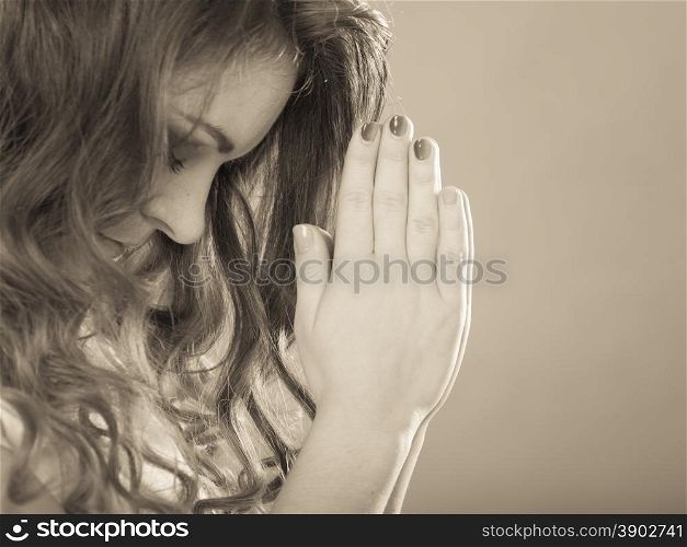 Religious woman praying to god jesus christ. Strong christian religion faith. Christianity. Sepia filter.. Woman praying to god jesus. Religion faith.