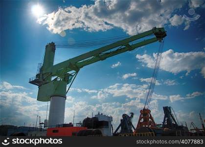 Reloading Crane over sunny sky background