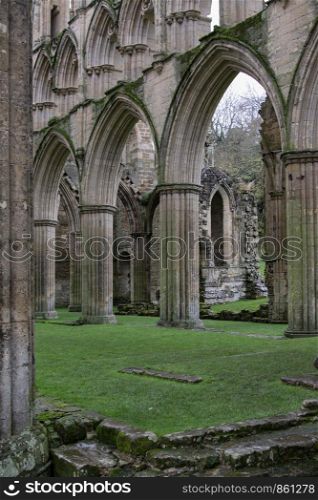 Remains of English ruin of an abbey with single columns arch