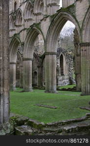 Remains of English ruin of an abbey with single columns arch