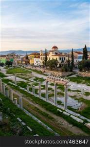 Remains of the Roman Agora and cityscape of Athens, Greece on a spring afternoon