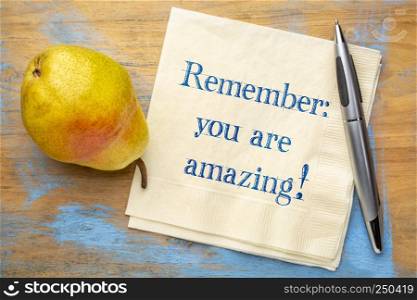 Remember - you are amazing! Inspirational handwriting on a napkin