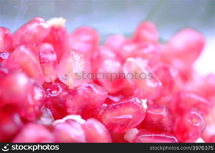 Remote background and Foreground blurry to emphasize the pomegranate seeds bright pink beautiful delicious