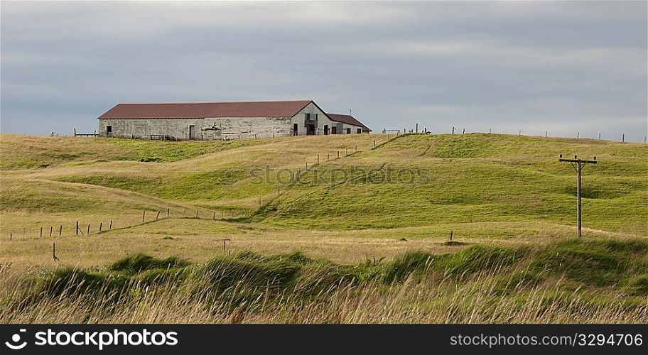 Remote farmland with telephone posed and wire fence