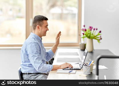 remote job, business and people concept - happy smiling middle-aged man with laptop computer working at home office and having video call. man with laptop having video call at home office