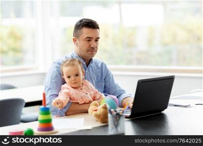 remote job, multi-tasking and family concept - middle-aged father in earphones with baby working at home office. father with baby working at home office