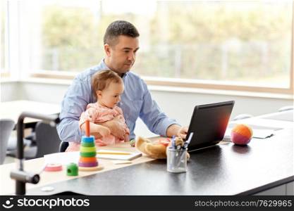 remote job, multi-tasking and family concept - middle-aged father with baby working on laptop at home office. father with baby working on laptop at home office