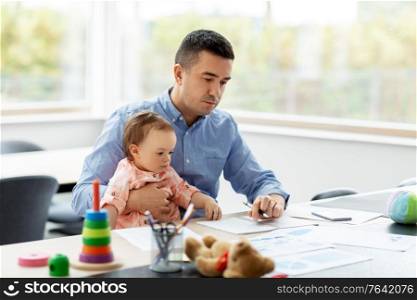 remote job, multi-tasking and family concept - middle-aged father with baby working at home office. father with baby working at home office