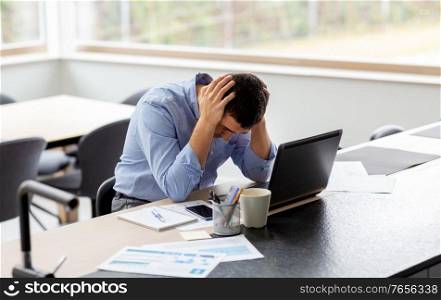 remote job, technology and business concept - stressed middle-aged man with laptop computer and papers working at home office. stressed man with laptop working at home office