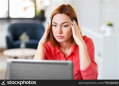 remote job, technology and people concept - tired or stressed young woman with laptop computer working at home office. stressed woman with laptop working at home office