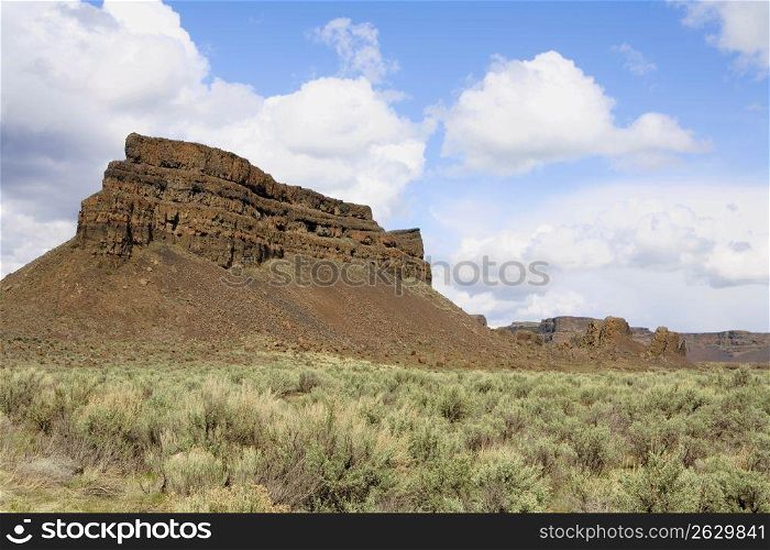 Remote rock formation in dry, scrubland landscape